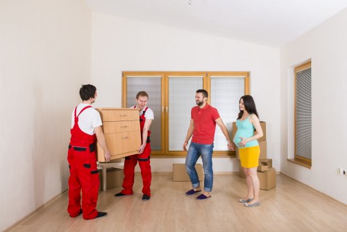 Professional movers loading items for a Kilburn relocation