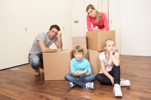 Local moving team handling boxes and furniture in Kilburn