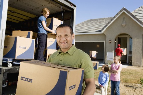 Professional removal team handling furniture and boxes for a Kilburn home move